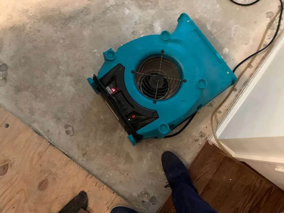 Air mover drying subfloor during Commercial Water Damage Restoration in Peachtree Corners